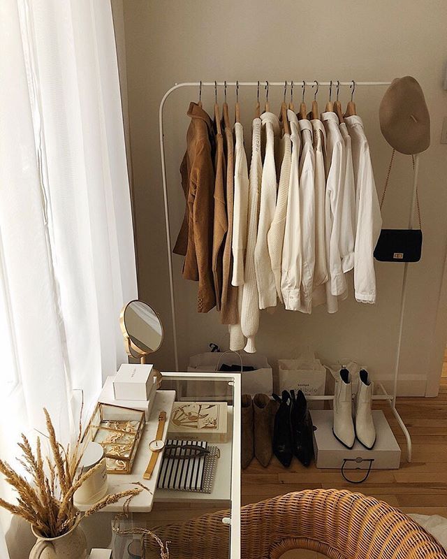 Curated capsule wardrobe rack with warm neutral tones